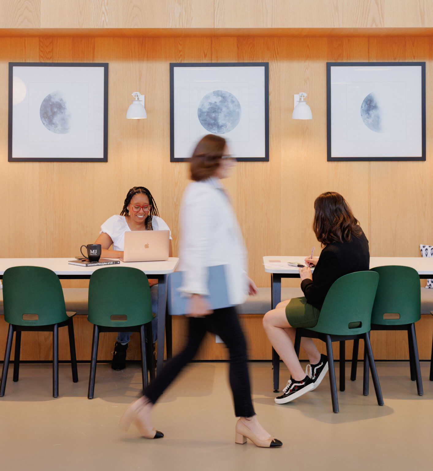 People working and walking in an office space.